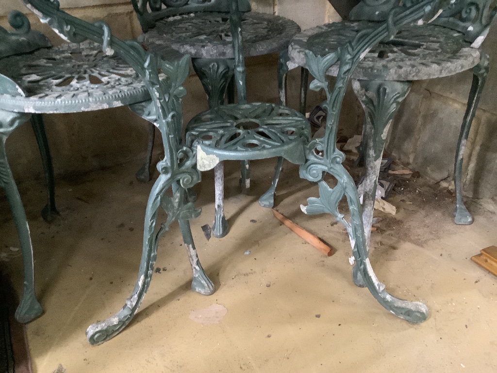 A Victorian style painted aluminium circular garden table with four chairs, table 81cm diameter height 67cm